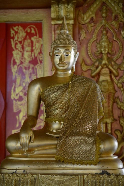 Free Golden Buddha statue sitting in a peaceful, ornate temple environment, symbolizing serenity and spirituality. Stock Photo
