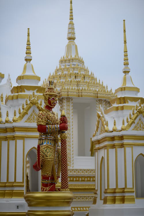 Gold and Red Statue Near the Temple