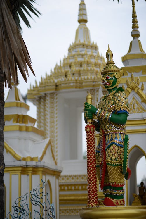 Green and Gold Statue Near the Temple