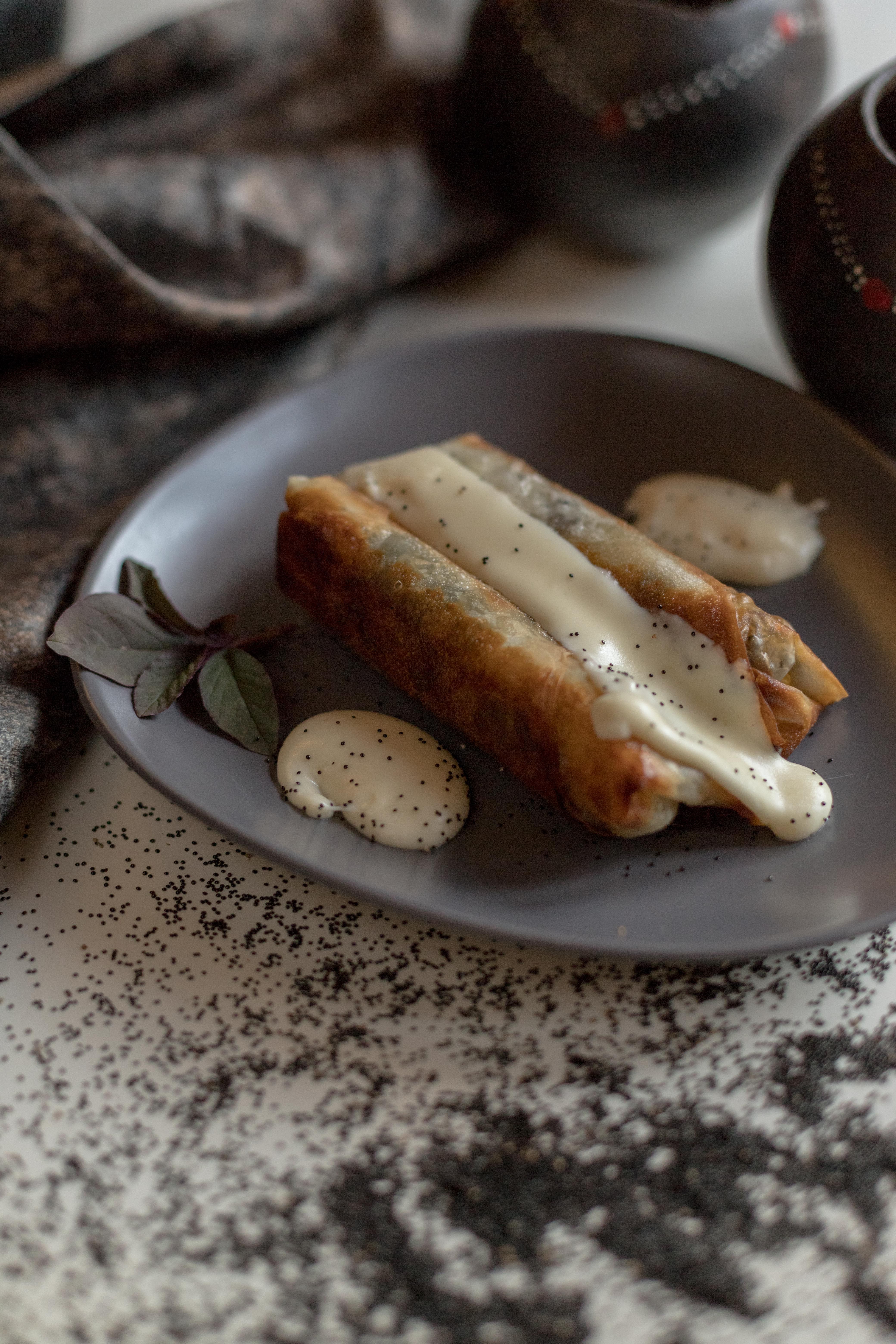 Delicious spring rolls with creamy drizzle, perfect for fine dining presentations.