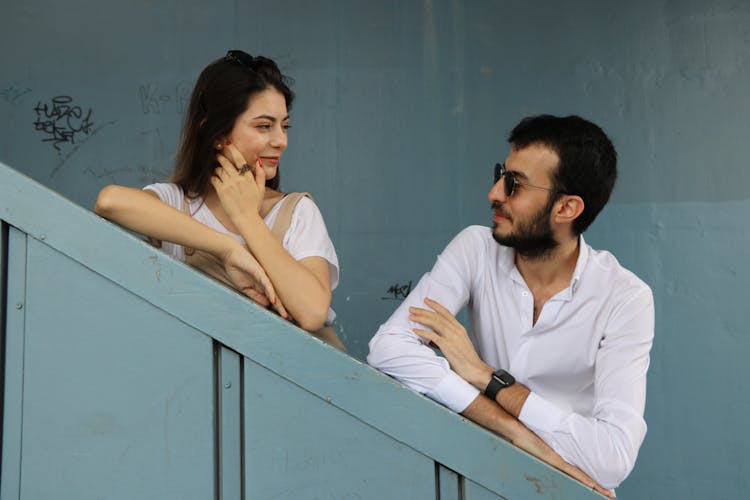 Couple Standing On Stairs Outdoors