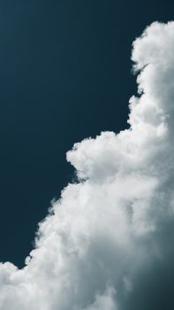 Striking image of a white cloud formation set against a deep blue sky, capturing the essence of a serene atmosphere.