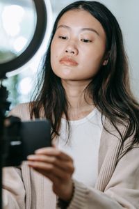 Creator filming a vertical clip on a phone — photo by Sasha Kim on Pexels