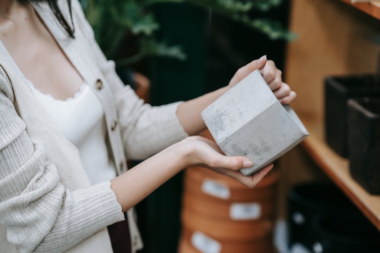 Person Holding A Matte Gray Ceramic Pot