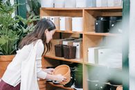 Woman in White Long Sleeve Shirt Holding Orange Plastic Cup