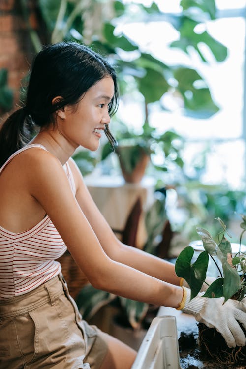 Smiling Woman holding a Plant 