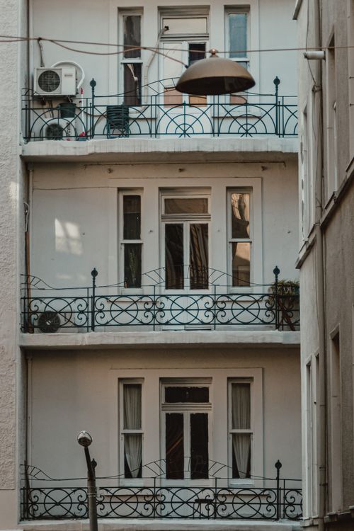Free Explore the classic design of urban balconies with elegant ironwork. Stock Photo