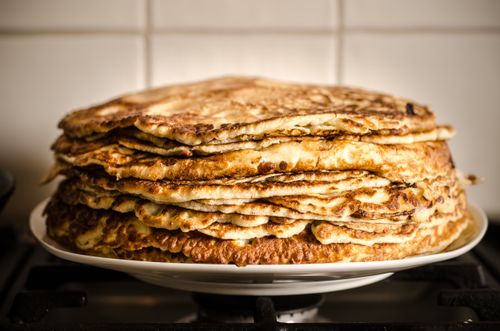 Free A mouthwatering stack of homemade pancakes on a white plate, perfect for breakfast. Stock Photo