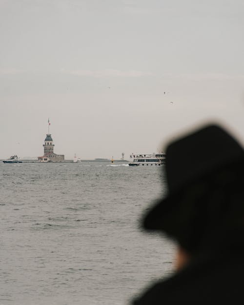 View of the Sea with a Silhouette of a Person Wearing a Hat 