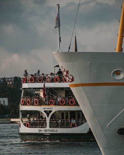 Free People Standing on White Boat Stock Photo