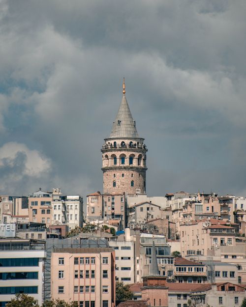 Free Beautiful view of Galata Tower amidst Istanbul's historic cityscape under dramatic clouds. Stock Photo