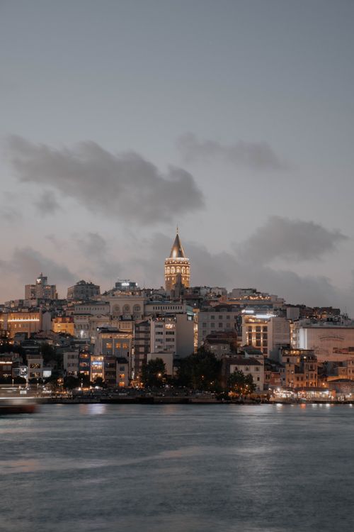 Free Evening cityscape of Istanbul showcasing the iconic Galata Tower across the waterfront. Stock Photo