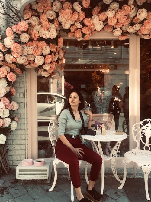 Stylish Woman sitting on a Metal chair 