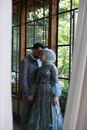 A Newly Wed Couple Standing Near the Window