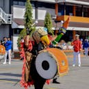 People in Yellow and Red Costume on Street