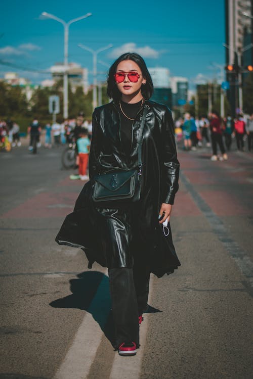 Woman in Black Leather Coat Walking on the Road