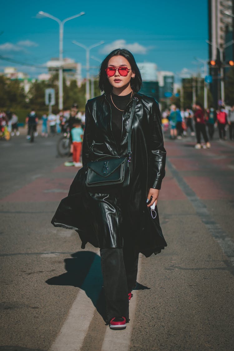 Woman In Black Leather Coat Walking On The Road