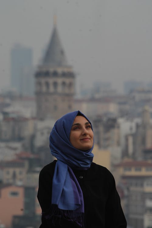 A Woman in Blue Hijab Looking Up