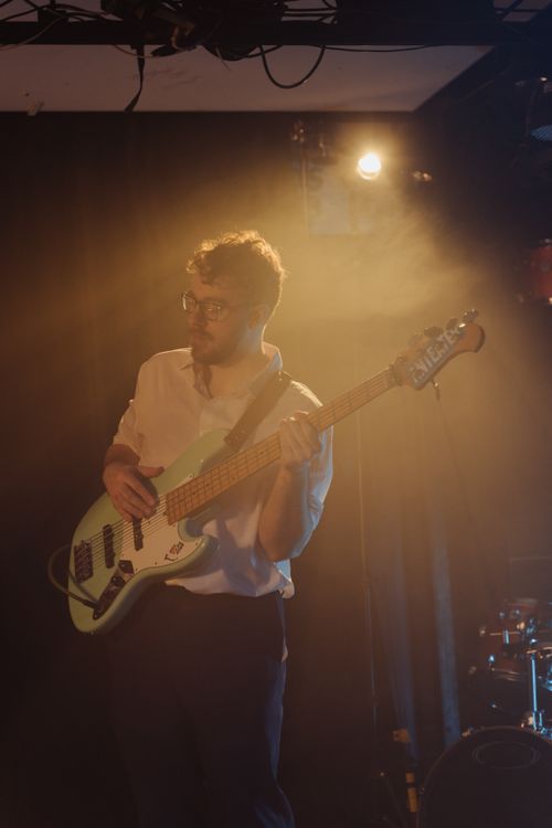 Free Bassist playing during a live music event with ambient lighting and jazz vibes. Stock Photo