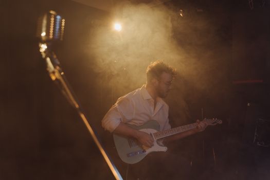 A Man in White Long Sleeves Playing Bass