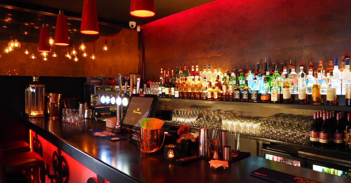 Enjoy the warm ambiance of a well-stocked, illuminated bar perfect for nightlife and celebrations.
