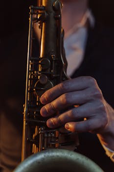 A detailed shot of a saxophonist performing with a brass saxophone, highlighting hand position.