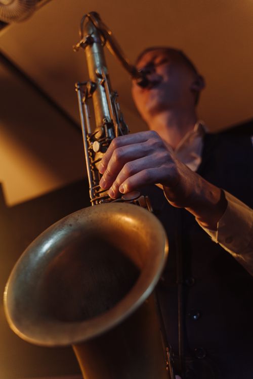 Free Low angle view of a musician passionately playing saxophone during a live performance. Stock Photo