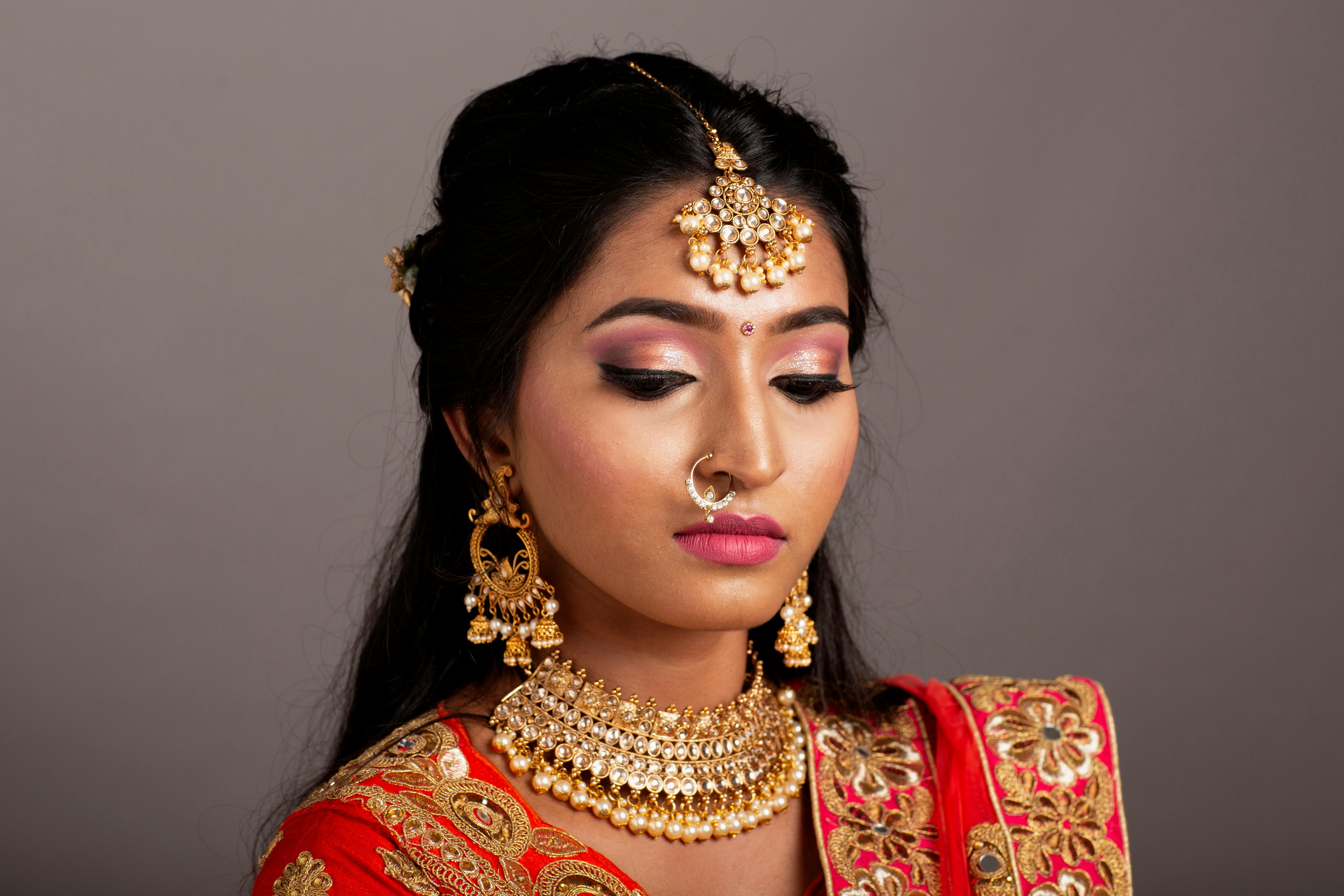 Close-up portrait of an elegant Indian woman in a traditional saree, adorned with beautiful jewelry.