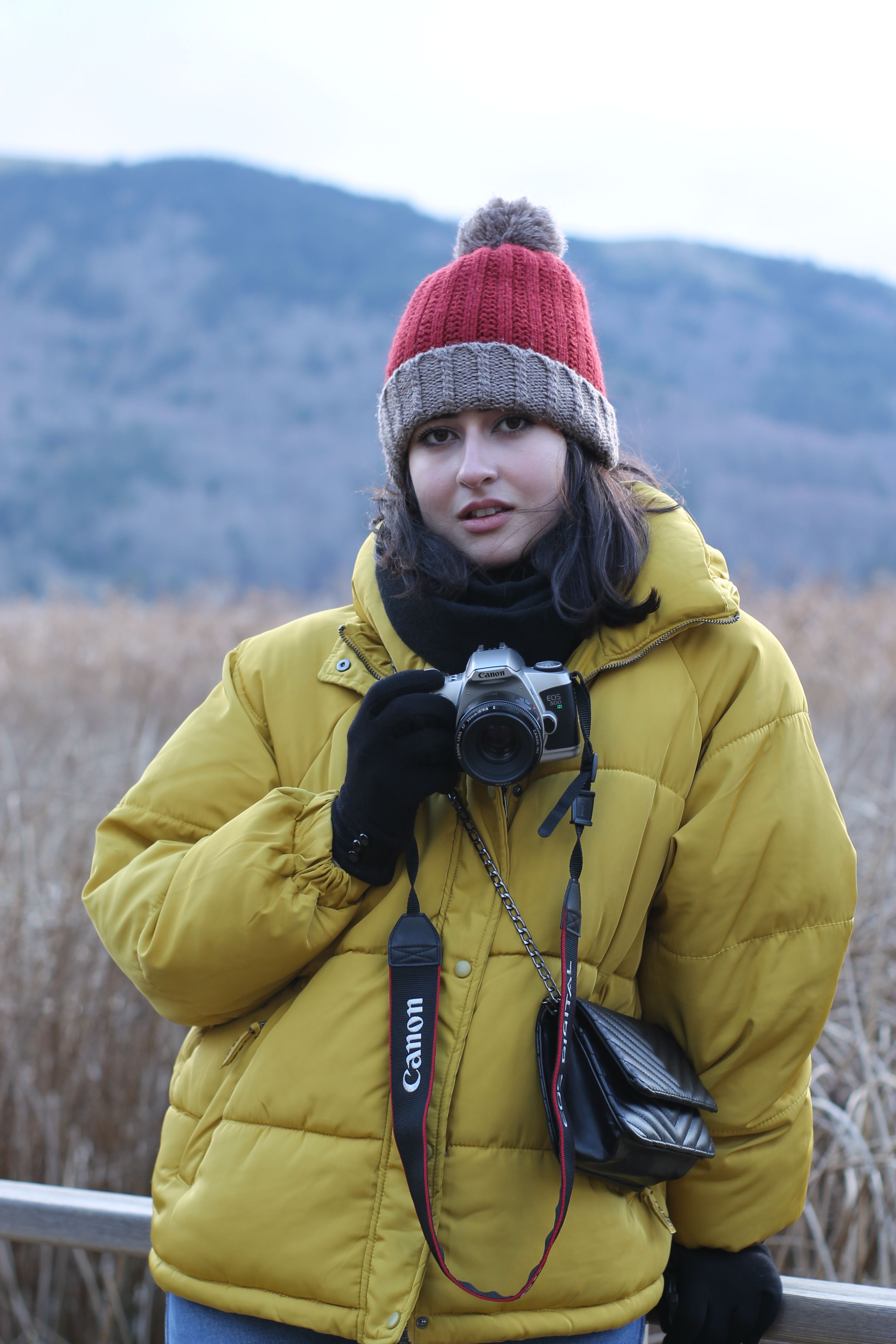 Woman in Yellow Jacket Holding Digital Camera · Free Stock Photo