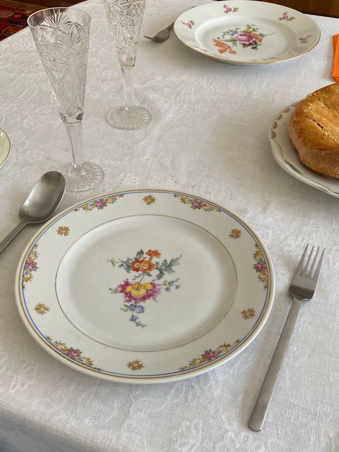 Charming dining table setup with floral plates and crystal glasses for a classic look.