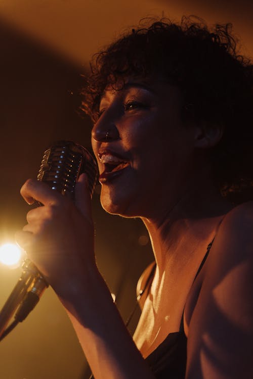 A Woman Singing on a Microphone