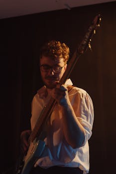 Musician playing bass guitar in an intimate jazz gig setting.