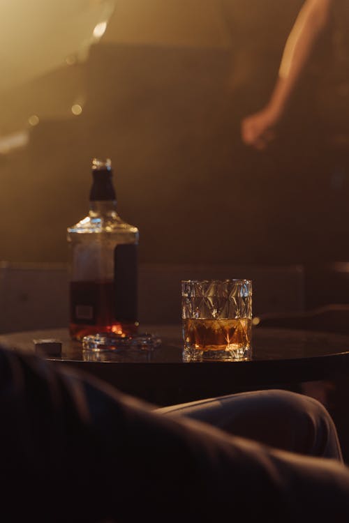 Whiskey Bottle Beside the Drinking Glass