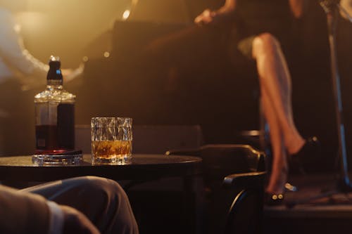 Photo of a Glass of Whiskey on a Black Table