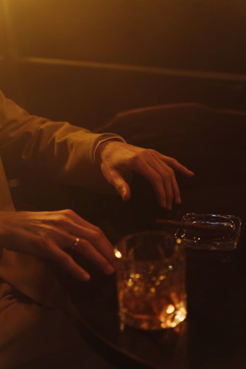 A Hands and Glass on the Table