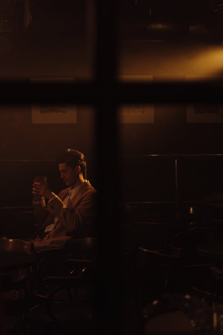 A Man Having A Drink In A Bar 