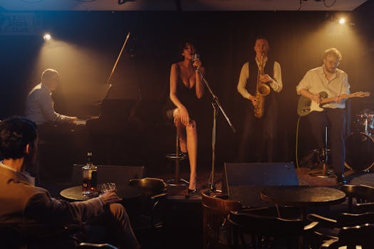 A jazz band performs live on stage in a dimly lit club with a singer and musicians playing various instruments.