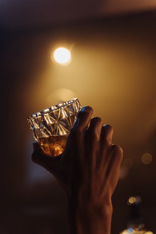 Close-Up Shot of a Person Holding a Glass of Whisky