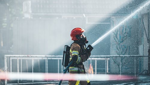 Free Photo of a Fireman Holding a Fire Hose Stock Photo