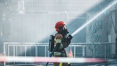 Man in Black and Red Helmet Holding Black and Yellow Power Tool