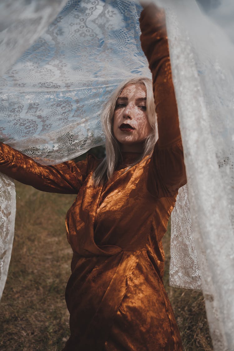 Woman In Brown Dress Covered With White Floral Lace Veil