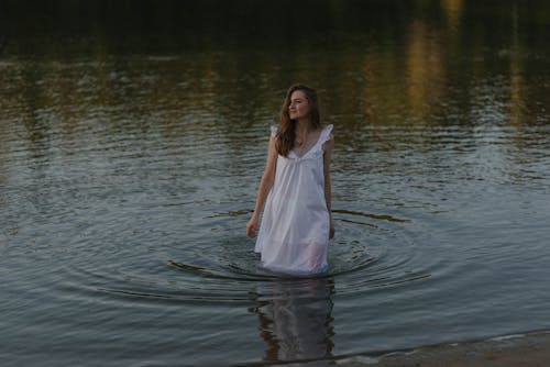 Woman in a White Dress on a Lake