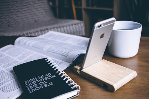 Book and Silver Iphone 6 on Top of Table