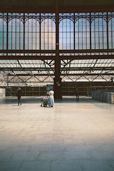 Wide-angle shot of Gare du Nord train station showcasing its architectural beauty with people walking.