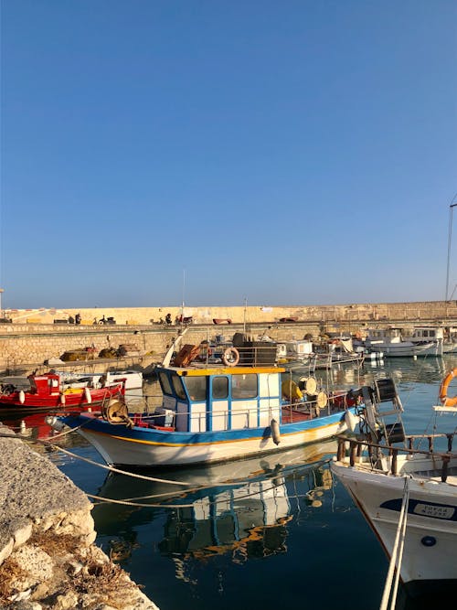 Free Fishing Boats on the Pier under the Blue Sky Stock Photo