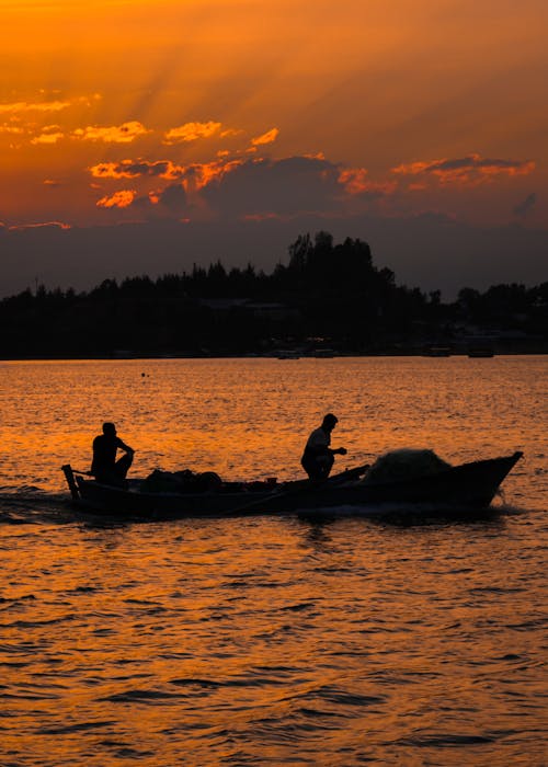 People Riding on the Boat During Sunset