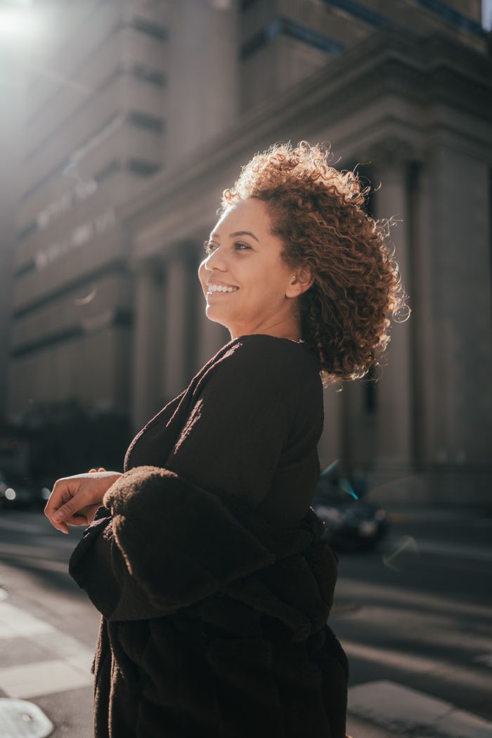 Smiling woman with voluminous curly hair