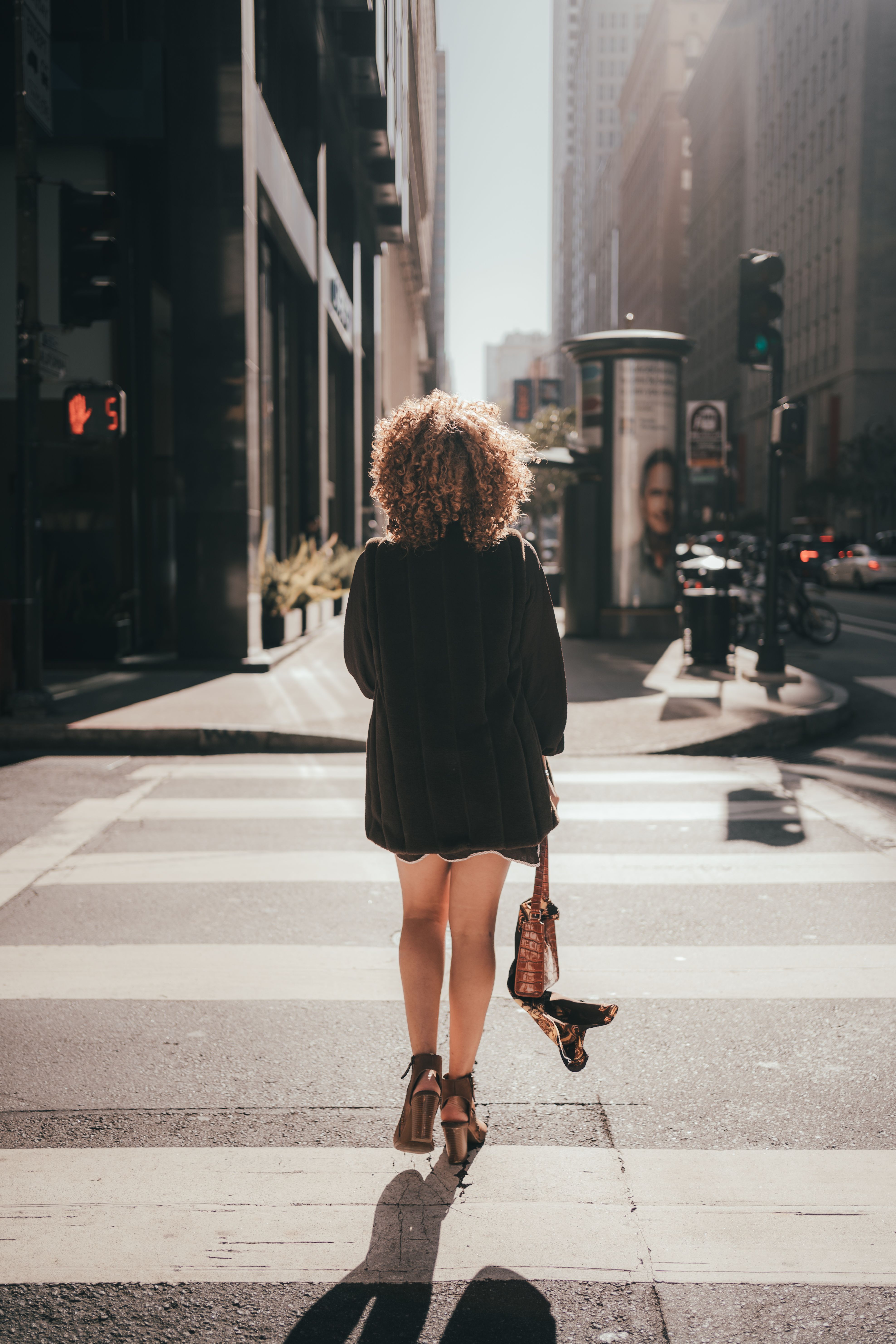 Woman in Black Coat Walking on Pedestrian Lane · Free Stock Photo