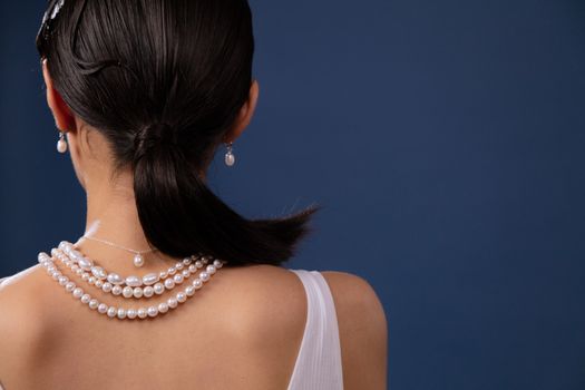Close-up of a woman wearing pearl jewelry, showcasing elegance and style.