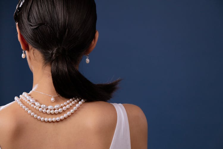 Back View Of A Woman Wearing Pearl Necklace